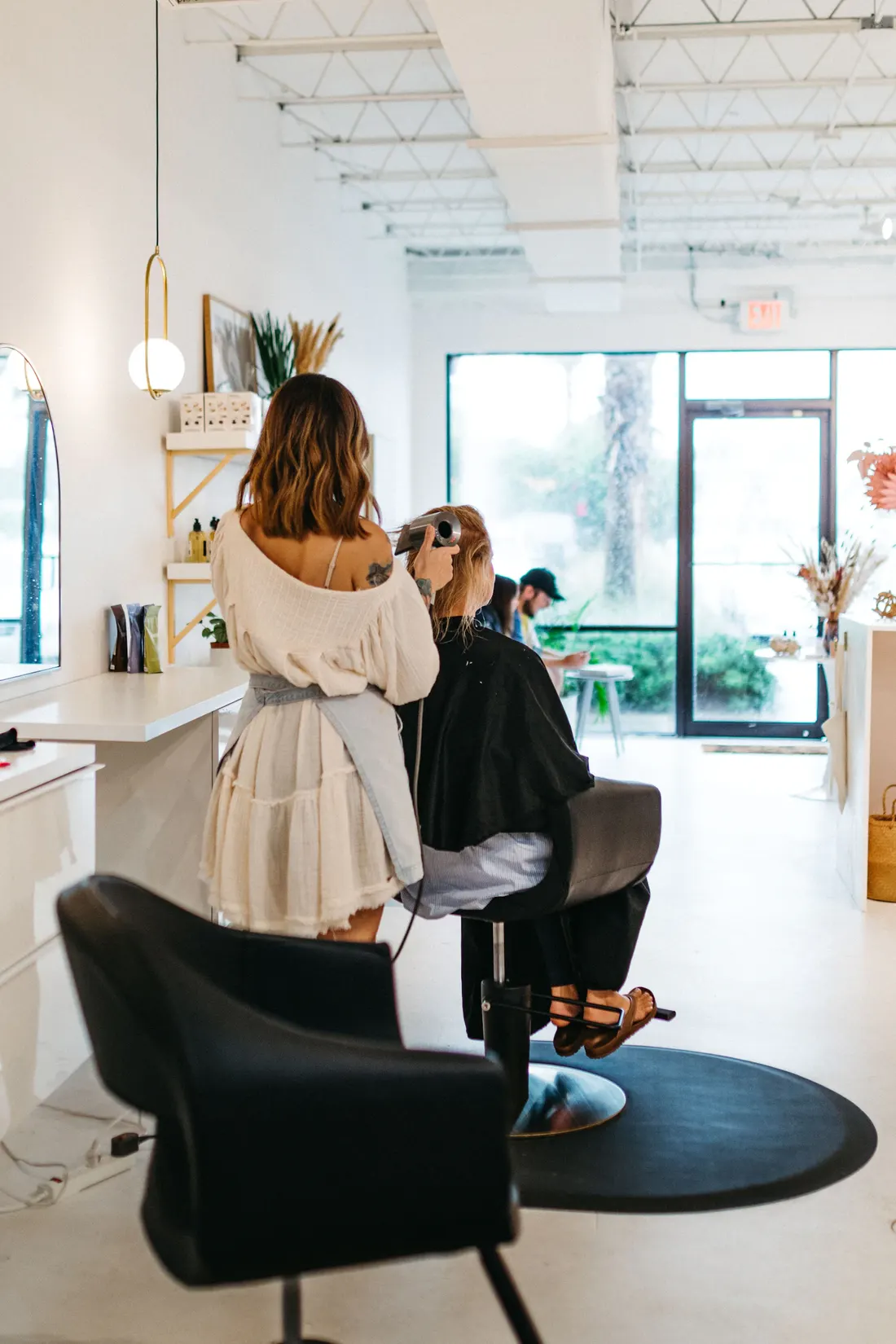 Inside Louelle Hair Studio — bright, plant-filled salon floor